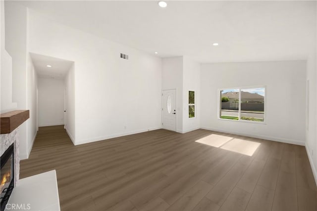 4082 N Flame Tree Ave, Rialto, CA 92377 - unfurnished living room featuring recessed lighting, a fireplace, and wood finished floors