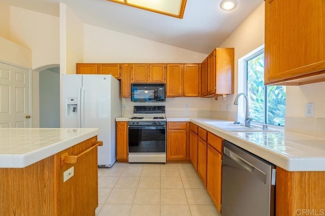 426 Debra An Dr, Fallbrook, CA 92028 - kitchen featuring white appliances, lofted ceiling, brown cabinets, and tile counters