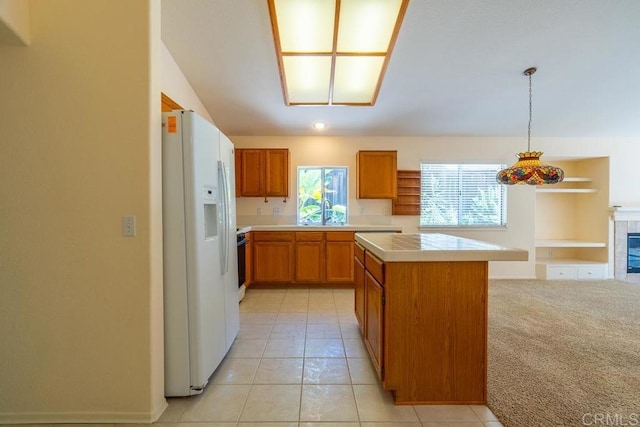 426 Debra An Dr, Fallbrook, CA 92028 - kitchen with white fridge with ice dispenser, healthy amount of natural light, brown cabinets, and a center island
