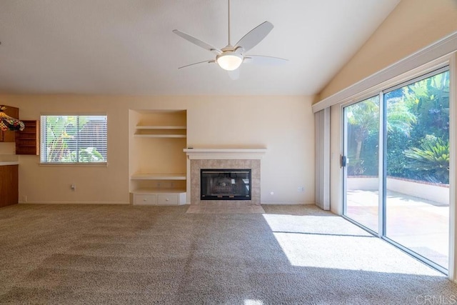 426 Debra An Dr, Fallbrook, CA 92028 - unfurnished living room with a tiled fireplace, carpet floors, vaulted ceiling, a ceiling fan, and built in features