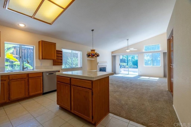 426 Debra An Dr, Fallbrook, CA 92028 - kitchen with dishwasher, lofted ceiling, light carpet, brown cabinetry, and a tile fireplace