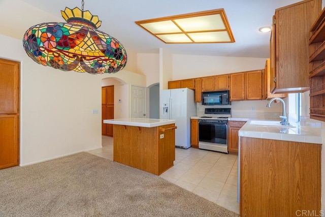 426 Debra An Dr, Fallbrook, CA 92028 - kitchen with white appliances, arched walkways, a kitchen island, brown cabinets, and light tile patterned floors