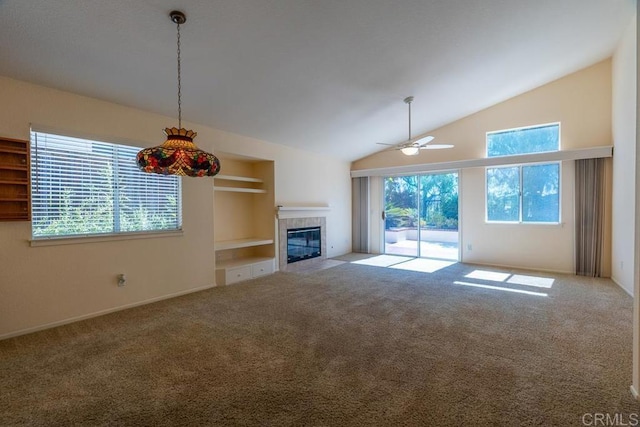 426 Debra An Dr, Fallbrook, CA 92028 - unfurnished living room featuring carpet flooring, a ceiling fan, lofted ceiling, a tile fireplace, and built in shelves