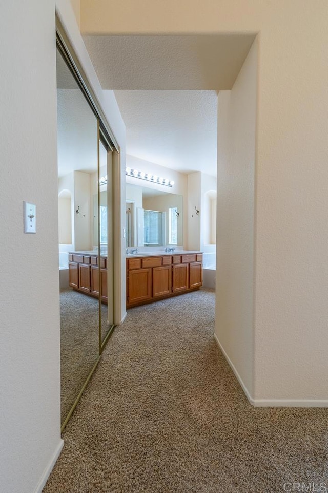 426 Debra An Dr, Fallbrook, CA 92028 - hallway with carpet floors and arched walkways