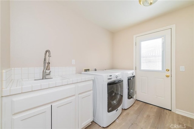27860 Mount Shasta Way, Yorba Linda, CA 92887 - laundry area featuring independent washer and dryer, cabinet space, and light wood-type flooring
