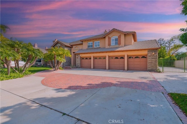 27860 Mount Shasta Way, Yorba Linda, CA 92887 - view of front of house with decorative driveway, a tile roof, a garage, stucco siding, and stone siding