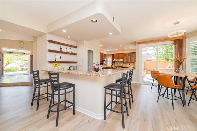 27860 Mount Shasta Way, Yorba Linda, CA 92887 - kitchen featuring open shelves, brown cabinets, light wood finished floors, a peninsula, and recessed lighting