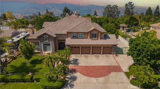 27860 Mount Shasta Way, Yorba Linda, CA 92887 - view of front of property featuring stone siding, driveway, a chimney, a tile roof, and stucco siding
