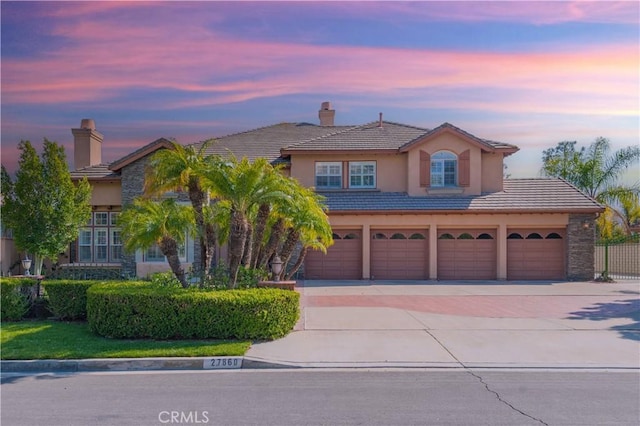 27860 Mount Shasta Way, Yorba Linda, CA 92887 - view of front of home with a chimney, driveway, a tile roof, and stucco siding