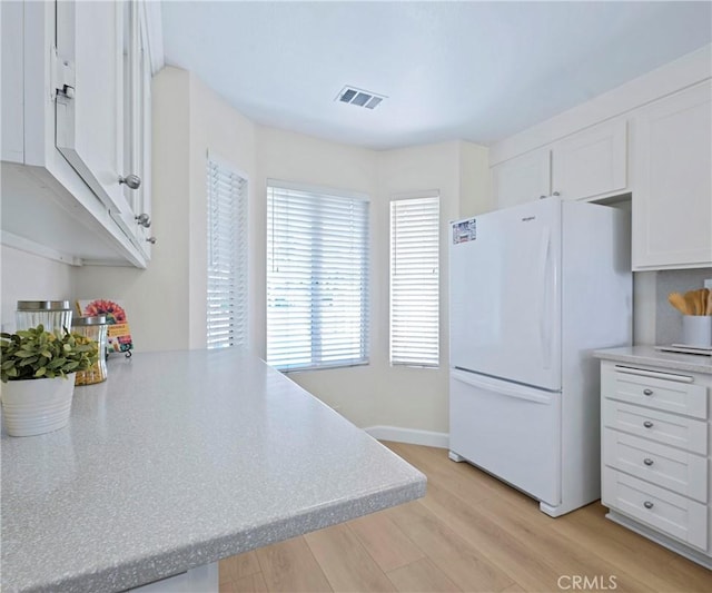 3610 Vista Glen Cir, Yorba Linda, CA 92886 - kitchen featuring freestanding refrigerator, white cabinets, light wood finished floors, light countertops, and a peninsula