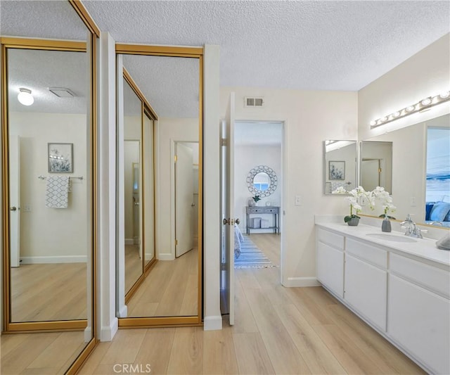 3610 Vista Glen Cir, Yorba Linda, CA 92886 - bathroom featuring wood finished floors, vanity, and a textured ceiling