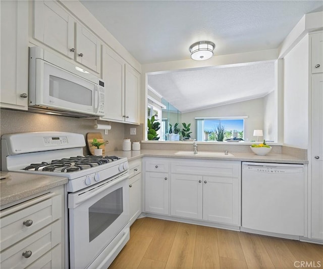 3610 Vista Glen Cir, Yorba Linda, CA 92886 - kitchen featuring white appliances, vaulted ceiling, white cabinetry, light countertops, and a textured ceiling