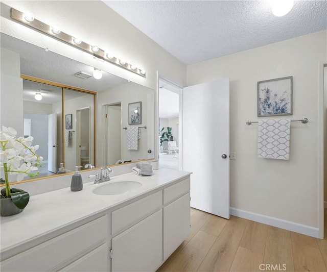 3610 Vista Glen Cir, Yorba Linda, CA 92886 - bathroom with wood finished floors, vanity, and a textured ceiling