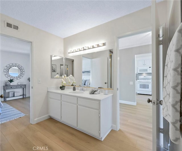 3610 Vista Glen Cir, Yorba Linda, CA 92886 - bathroom featuring wood finished floors, vanity, and a textured ceiling
