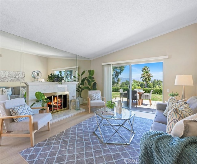 3610 Vista Glen Cir, Yorba Linda, CA 92886 - living room featuring lofted ceiling, wood finished floors, a textured ceiling, a high end fireplace, and crown molding