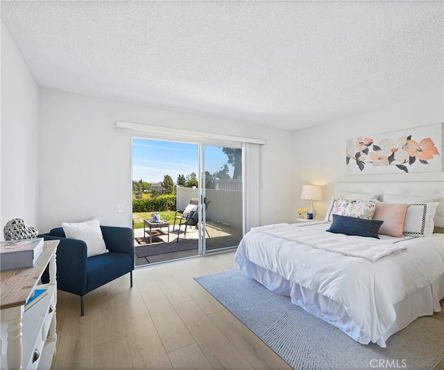 3610 Vista Glen Cir, Yorba Linda, CA 92886 - bedroom featuring access to exterior, light wood-style flooring, and a textured ceiling