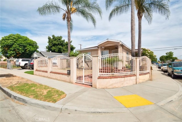 11457 Maza St, Norwalk, CA 90650 - view of front of home with a fenced front yard, a gate, and stucco siding