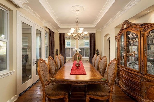 6767 Malachite Pl, Carlsbad, CA 92009 - dining room featuring french doors, a chandelier, arched walkways, a raised ceiling, and dark wood-style flooring