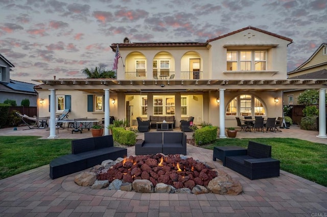 6767 Malachite Pl, Carlsbad, CA 92009 - back of property at dusk with an outdoor living space, a patio, outdoor dining area, and stucco siding