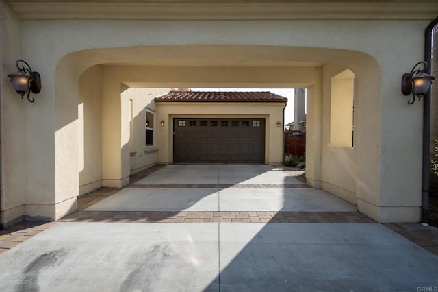 6767 Malachite Pl, Carlsbad, CA 92009 - entrance to property with stucco siding and concrete driveway