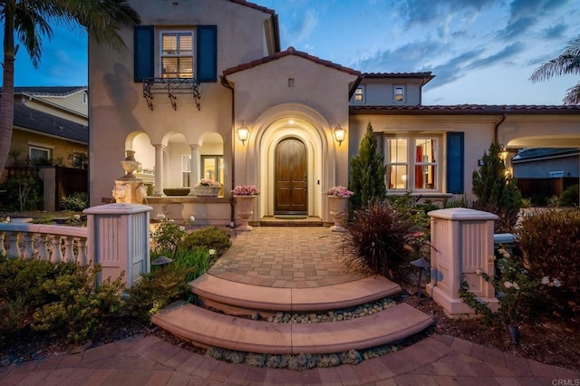 6767 Malachite Pl, Carlsbad, CA 92009 - property entrance with stucco siding and a tile roof