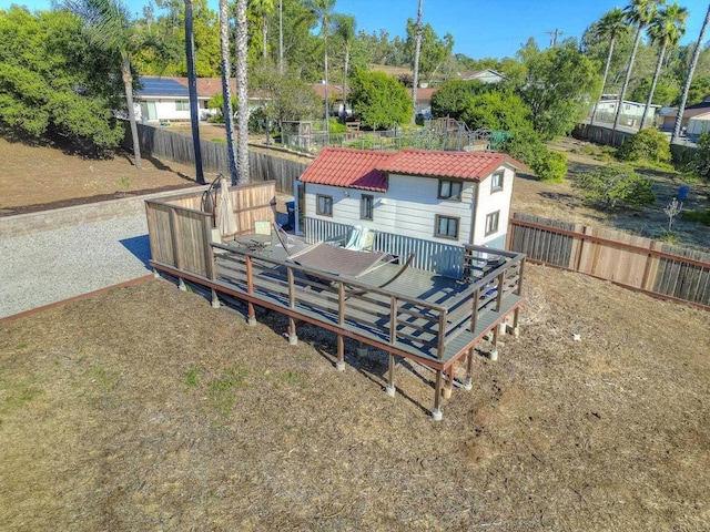 929 Chumash Trl, Vista, CA 92084 - rear view of house featuring a deck, a fenced backyard, and a tiled roof