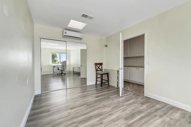 929 Chumash Trl, Vista, CA 92084 - spare room with a wall mounted AC and wood finished floors