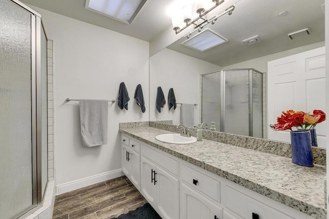 929 Chumash Trl, Vista, CA 92084 - full bath with vanity, a shower stall, and wood finished floors