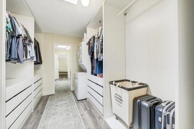 929 Chumash Trl, Vista, CA 92084 - walk in closet with stacked washer and clothes dryer and light wood-style floors