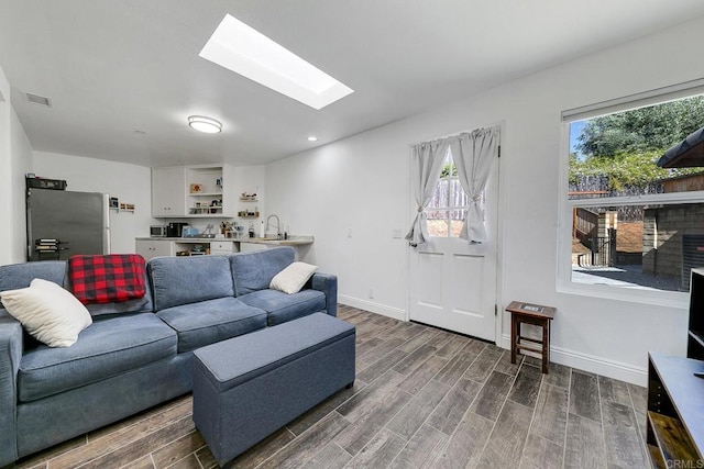 929 Chumash Trl, Vista, CA 92084 - living room featuring a skylight, dark wood-style flooring, and recessed lighting