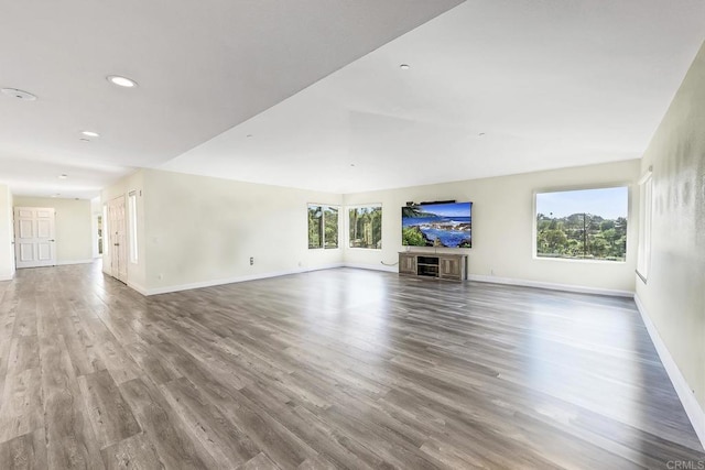 929 Chumash Trl, Vista, CA 92084 - unfurnished living room featuring wood finished floors, healthy amount of natural light, recessed lighting, and a glass covered fireplace