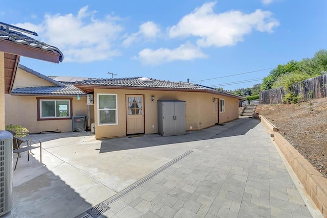 929 Chumash Trl, Vista, CA 92084 - back of property with a tiled roof, stucco siding, and a patio area