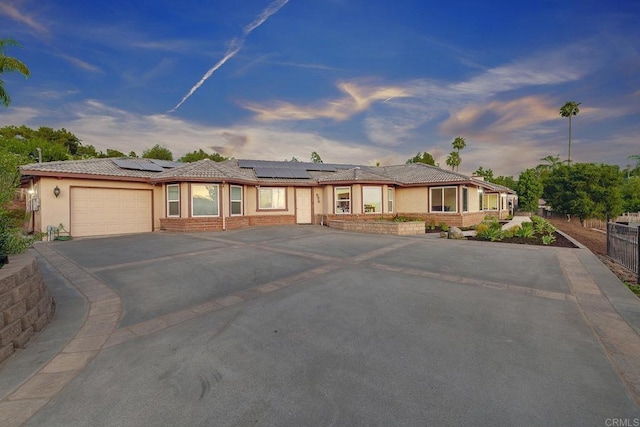 929 Chumash Trl, Vista, CA 92084 - ranch-style house featuring driveway, an attached garage, stucco siding, roof mounted solar panels, and a tile roof
