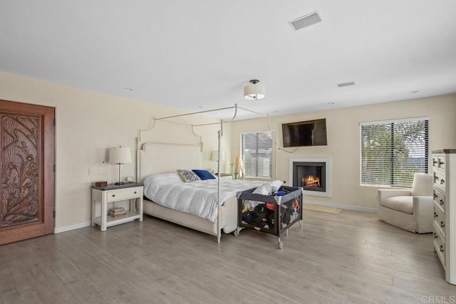 2044 Eula Ln, El Cajon, CA 92019 - bedroom with light wood finished floors and a warm lit fireplace