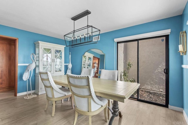 2044 Eula Ln, El Cajon, CA 92019 - dining area with wood finished floors, a chandelier, and arched walkways