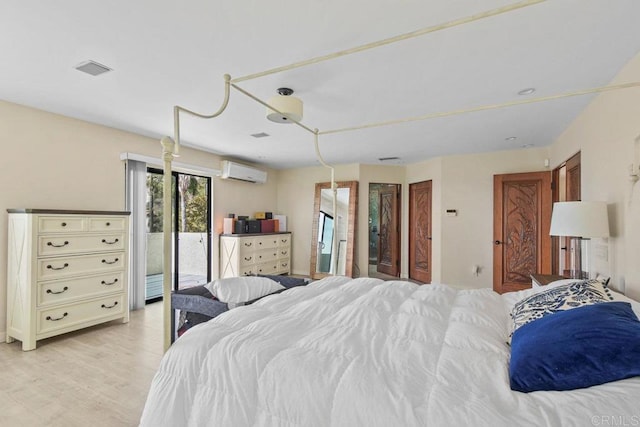 2044 Eula Ln, El Cajon, CA 92019 - bedroom with a wall mounted air conditioner, access to exterior, and light wood-type flooring