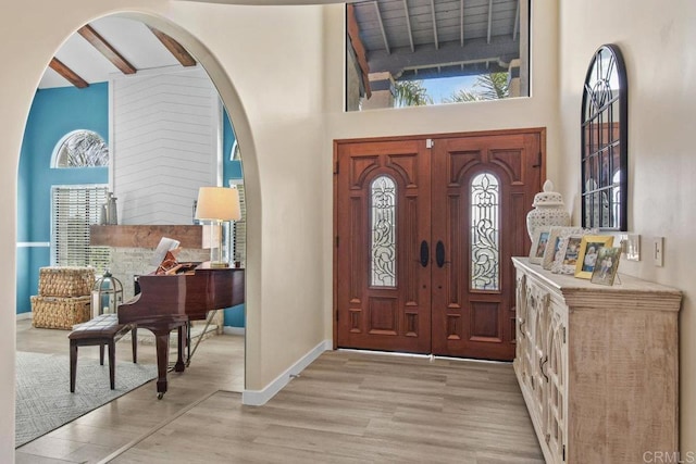 2044 Eula Ln, El Cajon, CA 92019 - entryway featuring healthy amount of natural light, a towering ceiling, light wood finished floors, and arched walkways
