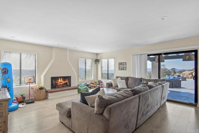 2044 Eula Ln, El Cajon, CA 92019 - living area featuring a lit fireplace, wood finished floors, healthy amount of natural light, and recessed lighting