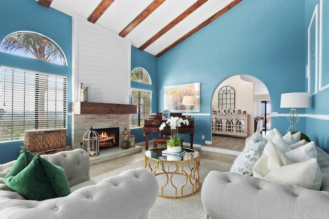 2044 Eula Ln, El Cajon, CA 92019 - living room featuring high vaulted ceiling, beam ceiling, wood finished floors, a fireplace, and arched walkways