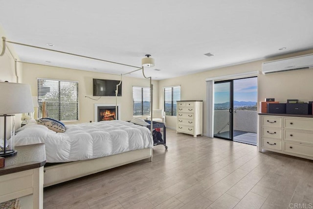 2044 Eula Ln, El Cajon, CA 92019 - bedroom featuring a wall mounted AC, access to outside, multiple windows, and wood finished floors
