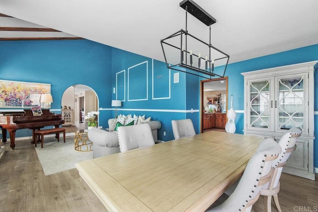 2044 Eula Ln, El Cajon, CA 92019 - dining area featuring a chandelier, wood finished floors, arched walkways, and lofted ceiling