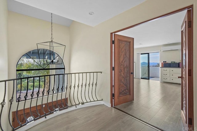 2044 Eula Ln, El Cajon, CA 92019 - hallway with a chandelier, wood finished floors, and a wall mounted air conditioner