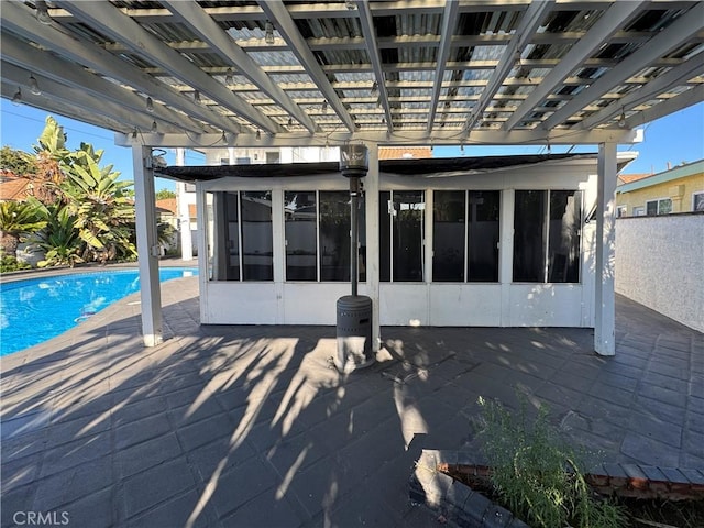 9135 Cord Ave, Downey, CA 90240 - rear view of house featuring a pergola, an outdoor pool, a sunroom, and a patio area