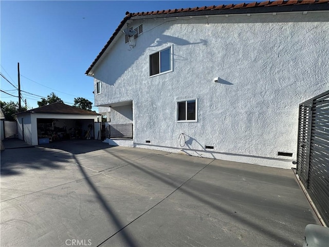 9135 Cord Ave, Downey, CA 90240 - back of property featuring stucco siding, crawl space, and an outbuilding