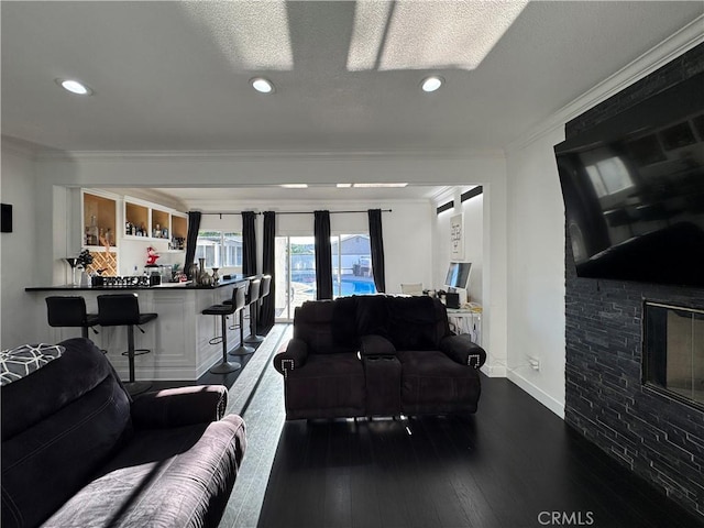 9135 Cord Ave, Downey, CA 90240 - living room featuring ornamental molding, recessed lighting, dark wood-type flooring, bar area, and a textured ceiling
