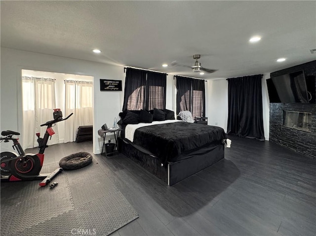 9135 Cord Ave, Downey, CA 90240 - bedroom featuring a glass covered fireplace, recessed lighting, dark wood-style flooring, and a ceiling fan