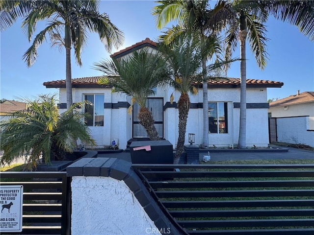 9135 Cord Ave, Downey, CA 90240 - mediterranean / spanish-style house with a tiled roof, stucco siding, and a fenced front yard