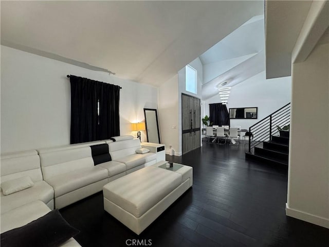 9135 Cord Ave, Downey, CA 90240 - living area with vaulted ceiling, dark wood-type flooring, and stairs