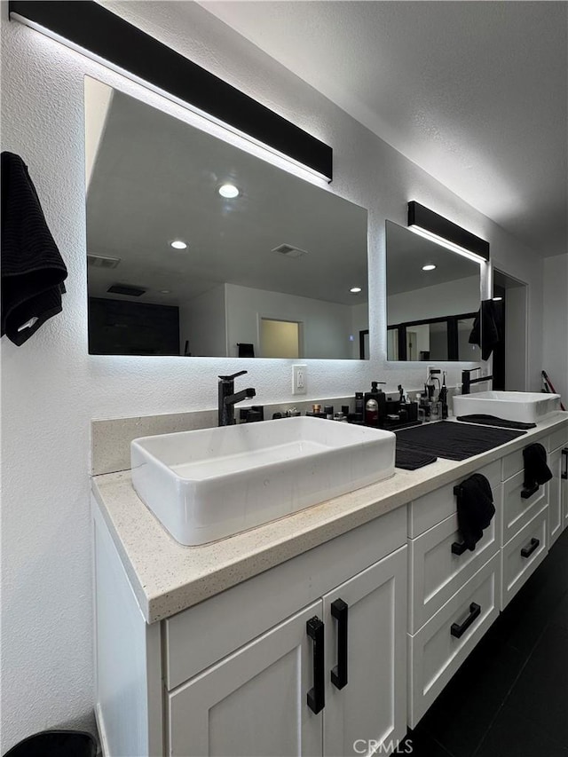 9135 Cord Ave, Downey, CA 90240 - full bathroom with double vanity and a textured wall