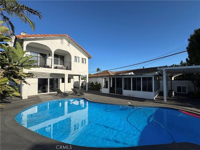 9135 Cord Ave, Downey, CA 90240 - outdoor pool featuring a sunroom and a patio area